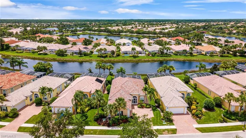 Birds eye view of property with a water view