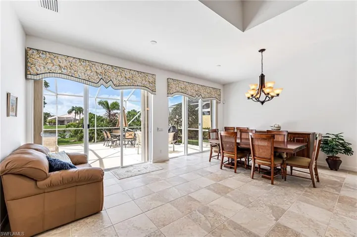 Dining space with a chandelier and light tile floors