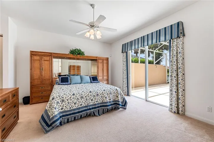 Bedroom with access to outside, light carpet, and ceiling fan