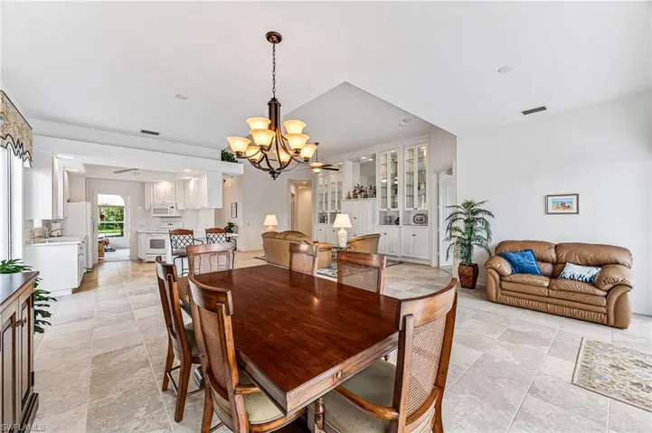 Tiled dining area with sink and an inviting chandelier