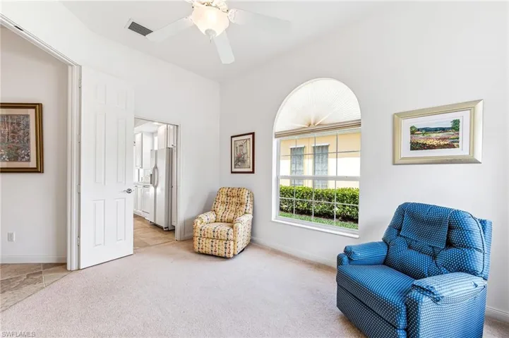 Sitting room featuring ceiling fan and light tile floors