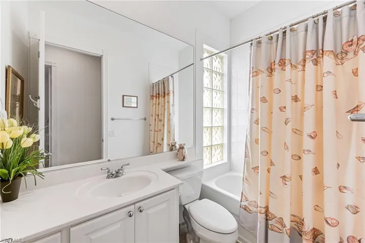 Full bathroom with oversized vanity, toilet, and shower / tub combo