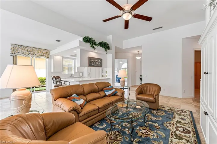 Tiled living room featuring ceiling fan