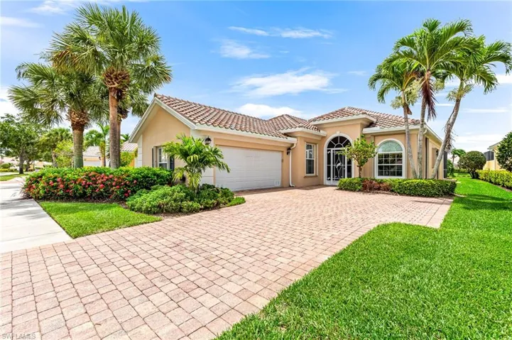 Mediterranean / spanish-style home with a front lawn and a garage