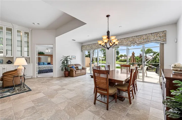 Dining room with a chandelier and light tile floors
