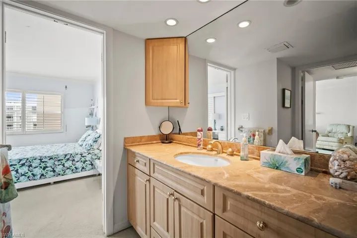 Ensuite bathroom with vanity and recessed lighting