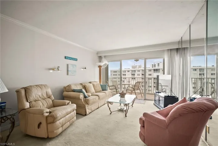 Carpeted living room featuring ornamental molding