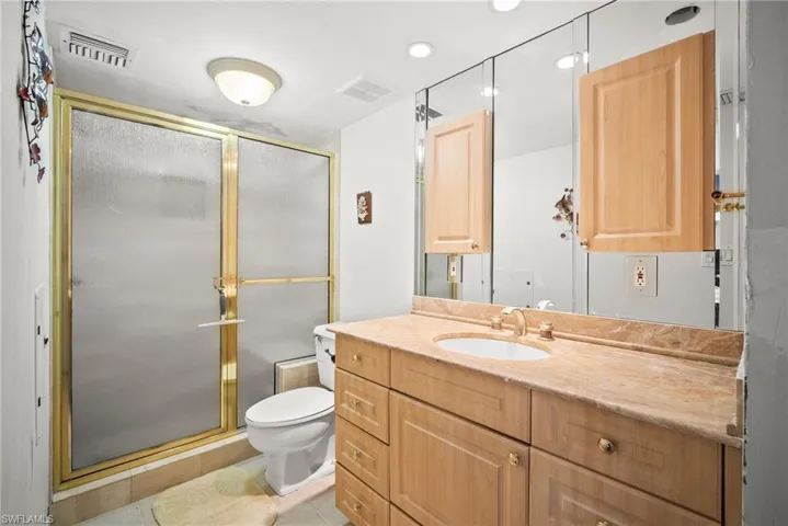 Full bathroom featuring vanity and a stall shower