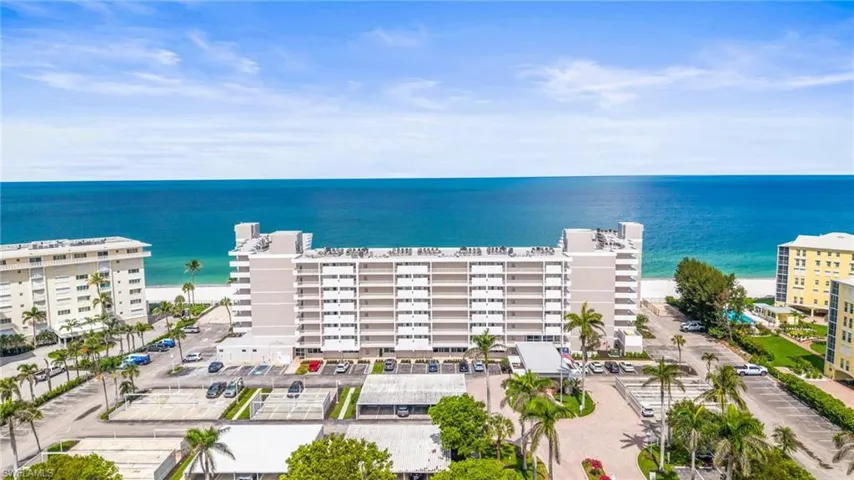 Aerial view of apartment complex / building and a nearby body of water
