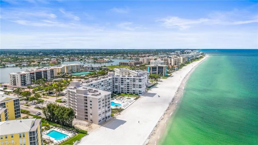 Drone / aerial view of expansive beach and a pool