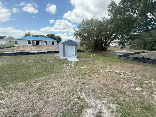 View of yard with a storage shed and an outbuilding