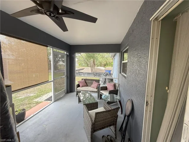 Sunroom / solarium featuring ceiling fan