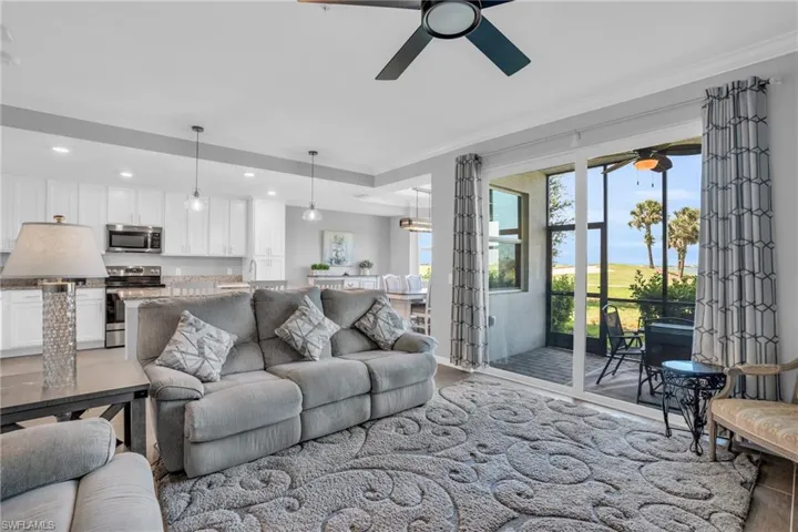Living room featuring ceiling fan and crown molding