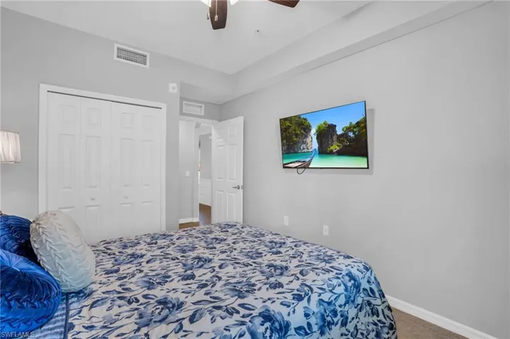 Bedroom featuring carpet, a closet, and ceiling fan