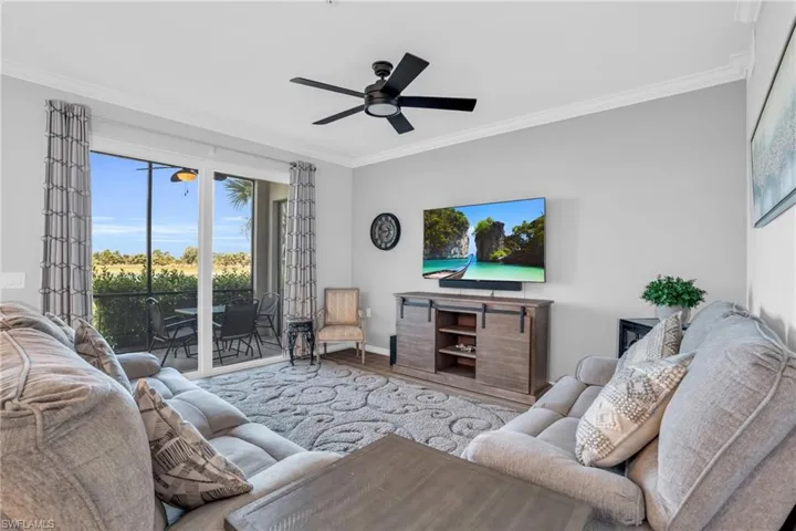 Living room with ceiling fan, ornamental molding