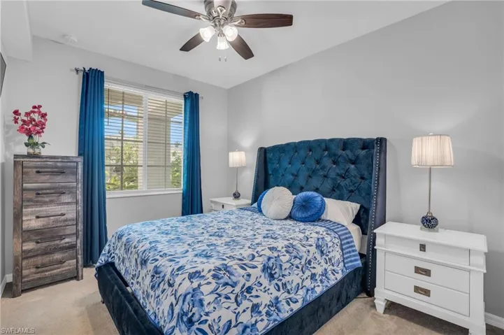 Carpeted bedroom with ceiling fan