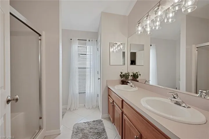 Primary bathroom with dual sinks and walk in shower.
