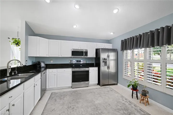 Large window overlooks landscaped area.