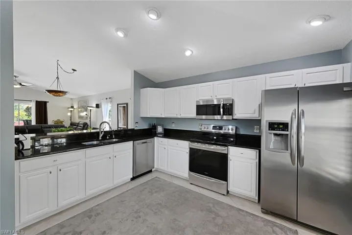 Bright, open kitchen with stainless appliances.