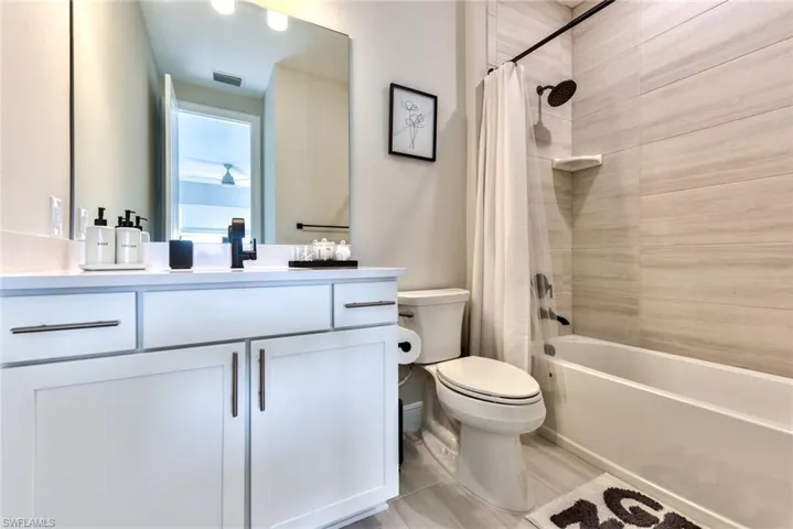 Bathroom featuring shower / tub combo and vanity
