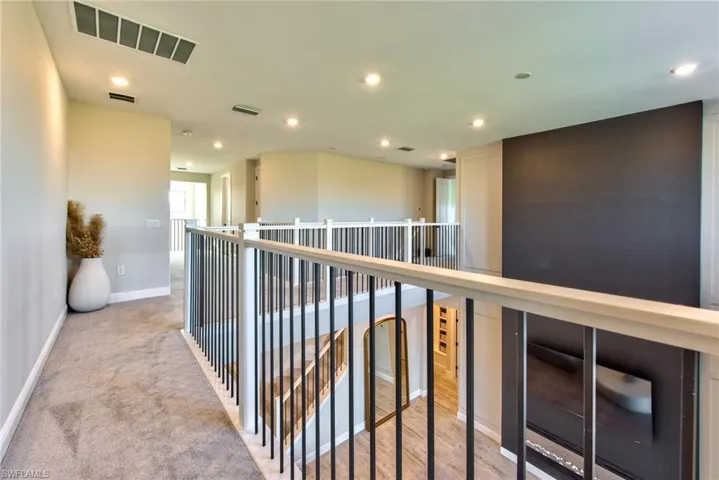 Hall featuring recessed lighting and light colored carpet