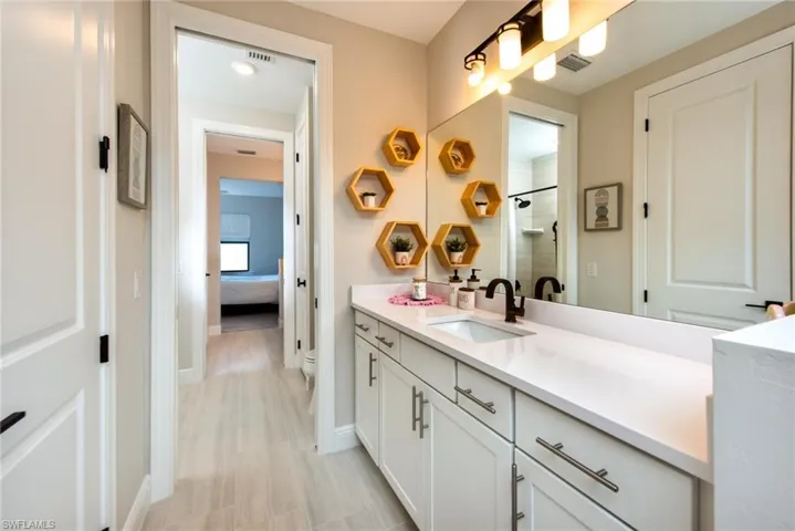 Ensuite bathroom with vanity and tiled shower