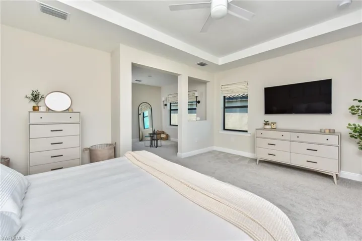 Carpeted bedroom featuring baseboards and ceiling fan