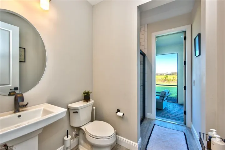 Bathroom with toilet and wood finished floors