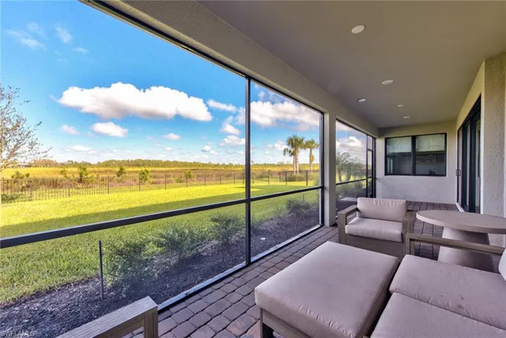 Sunroom / solarium with a view of countryside and an outdoor living space