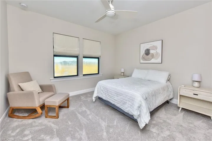 Carpeted bedroom with baseboards and ceiling fan