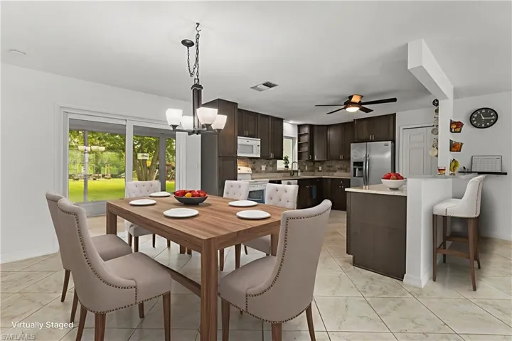 Dining space featuring a chandelier and a ceiling fan