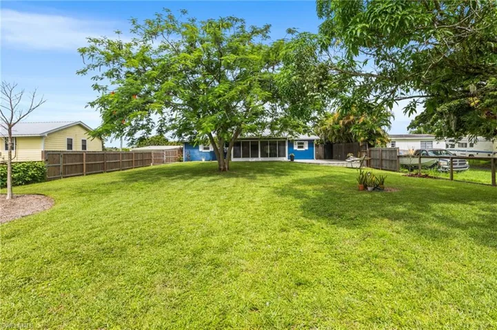 Fenced backyard with a sunroom