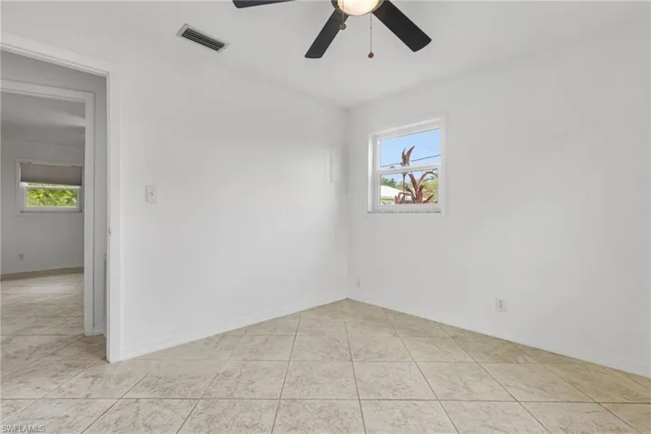 Unfurnished room featuring a ceiling fan and light tile patterned floors