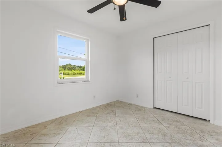 Unfurnished bedroom with a closet and ceiling fan