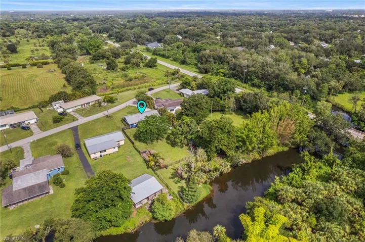 Aerial view of property's location with a nearby body of water