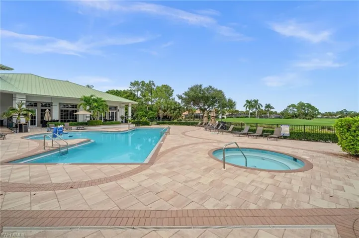 Community pool featuring a patio area and a hot tub