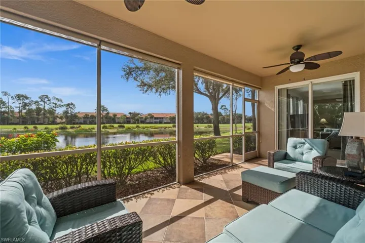 Sunroom featuring outdoor lounge area, a ceiling fan, and a water view