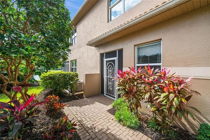 Doorway to property with stucco siding and a patio
