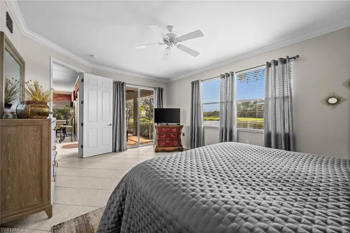 Bedroom featuring ornamental molding, a ceiling fan, access to exterior, and light tile patterned flooring