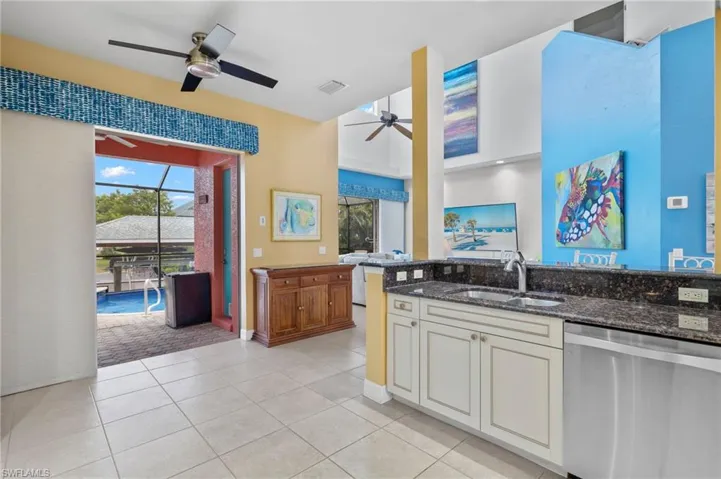 Kitchen, Living Room with 20' ceiling, and pocket sliders to pool bath and covered dining in the lanai.