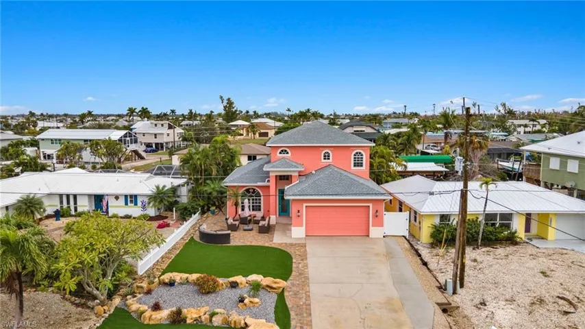Aerial of home with lots of parking and maintenance-free front yard.