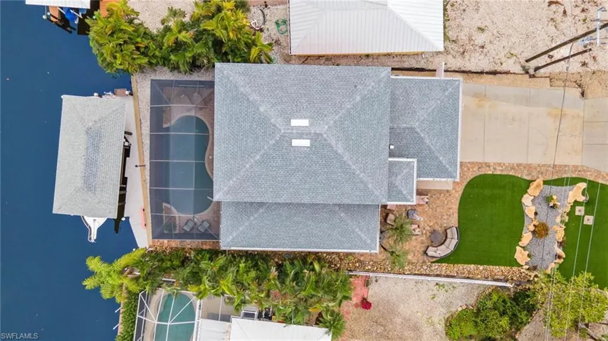 Aerial of home, pool, lift, and maintenance-free lawn.