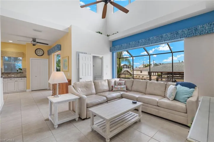 Living Room has pocket sliders to the screened pool and lanai, and pool bath for easy access to the pool.