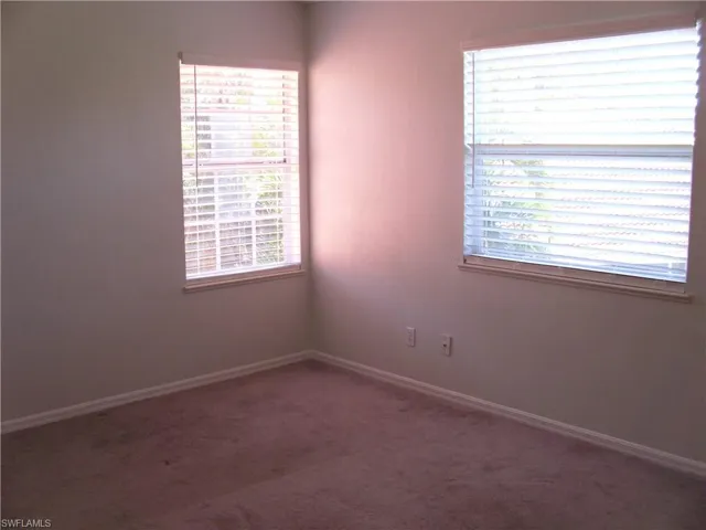 Carpeted bedroom with baseboards
