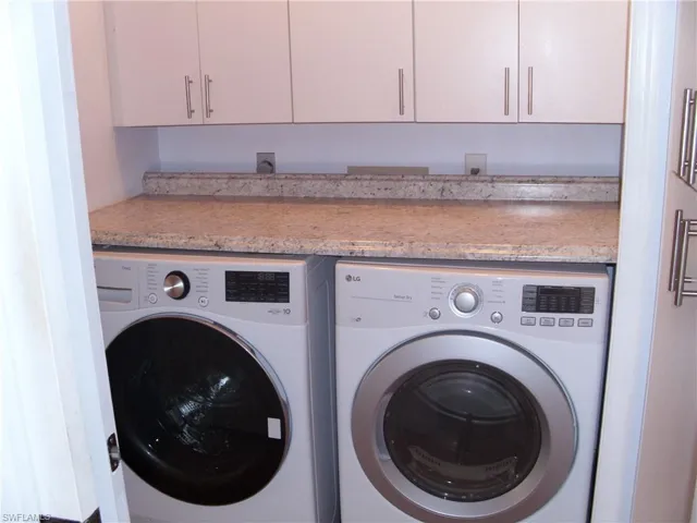 Laundry area with washing machine and clothes dryer and cabinet space