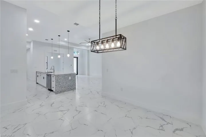 Unfurnished dining area with recessed lighting, light marble finish floors, and ceiling fan