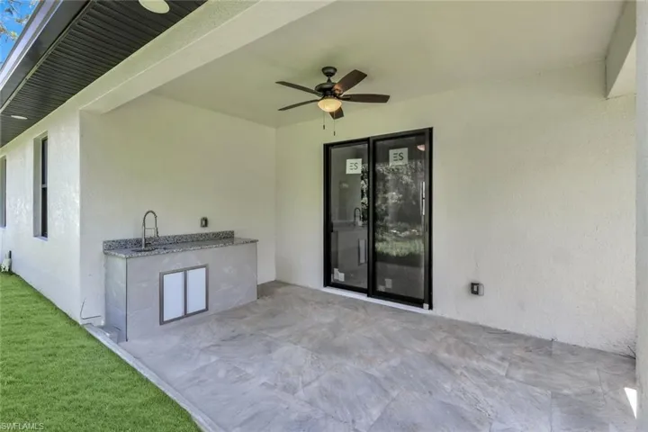 View of patio / terrace with a ceiling fan and an outdoor kitchen