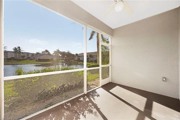 Unfurnished sunroom with a water view and ceiling fan