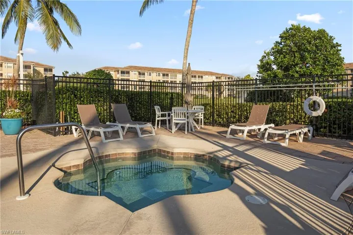 View of swimming pool with a community hot tub and a patio area