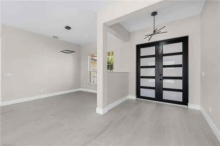 Entryway featuring the dining area, french doors, and light porcelain tile flooring